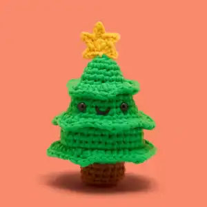 Crocheted Christmas tree with smiling face and star.