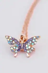 Colorful gemstone butterfly pendant on a chain.