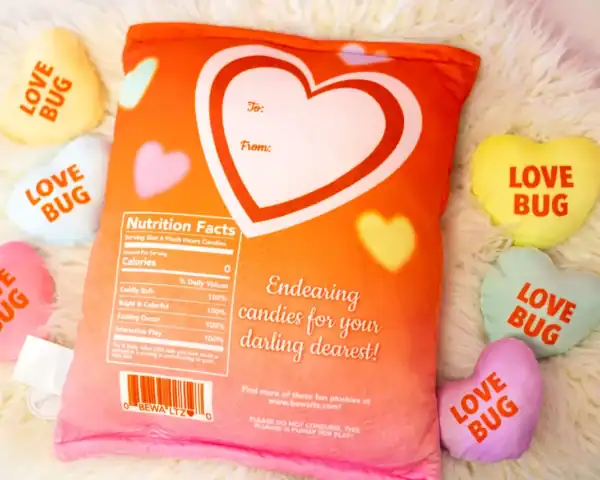 Plush heart candy pillows with 'Love Bug' text.