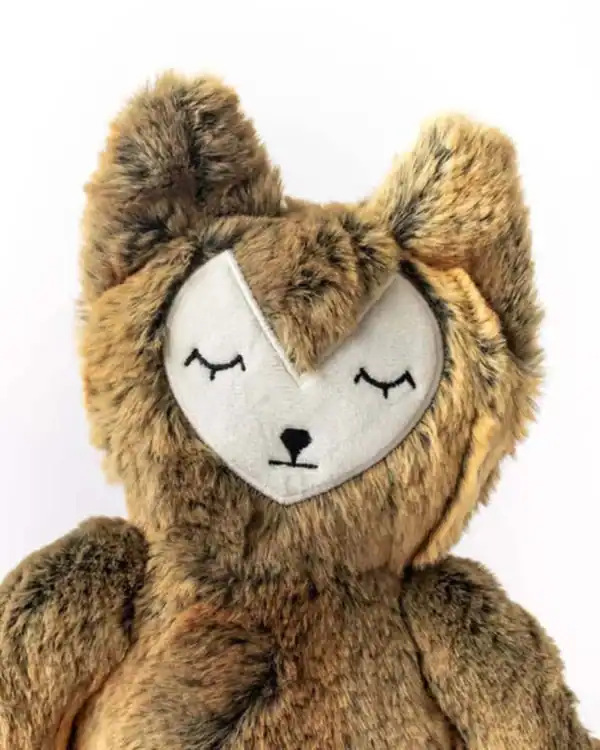 Plush fox toy with closed eyes and fluffy fur.