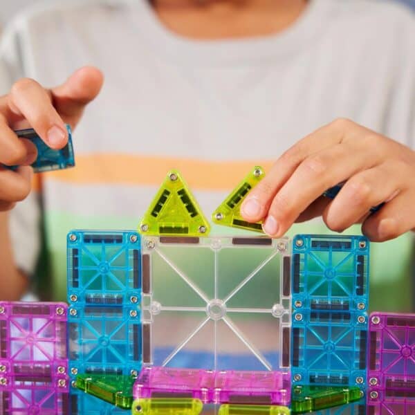 Child playing with colorful magnetic blocks.