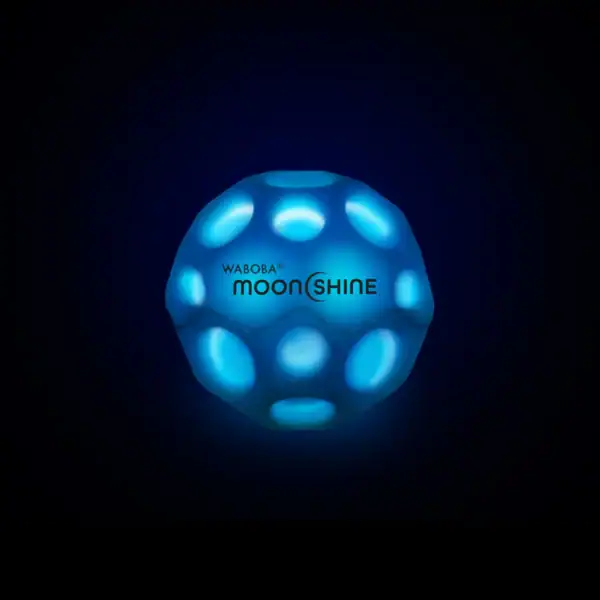Glowing blue Waboba Moonshine ball in darkness.