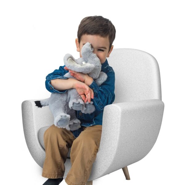 Child hugging elephant stuffed animal on chair