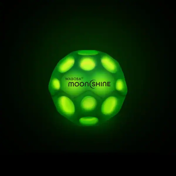 Glowing green Waboba Moonshine ball on black background.