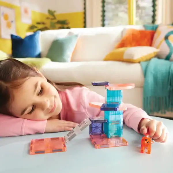 Child playing with colorful magnetic building blocks.