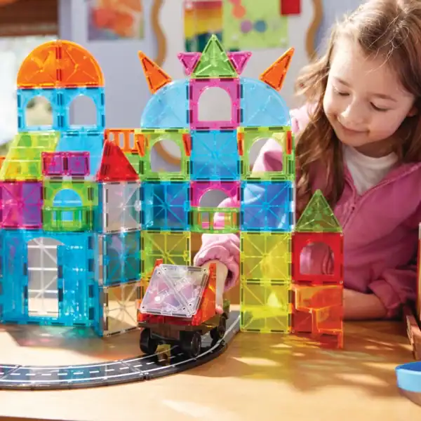 Child playing with colorful magnetic building blocks.