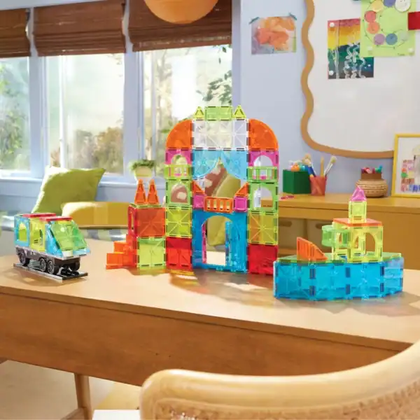 Colorful magnetic building blocks on wooden table.