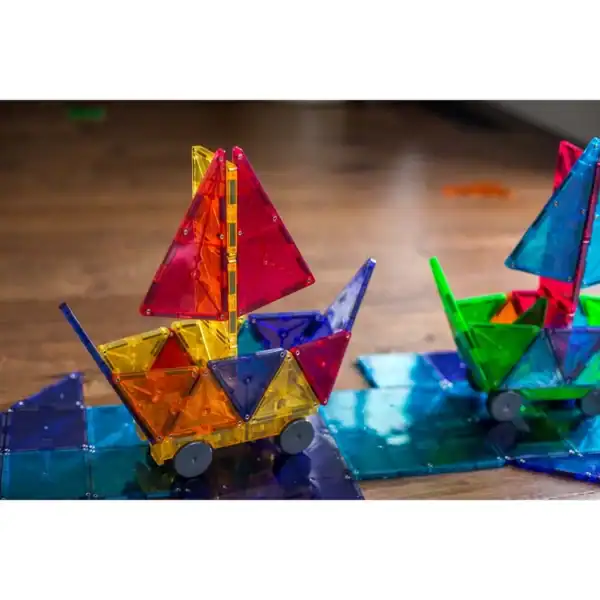 Colorful magnetic toy boats on wooden floor