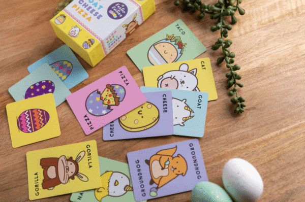 Colorful animal-themed card game on wooden table.