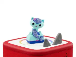 Toy cat figurine on red speaker box.