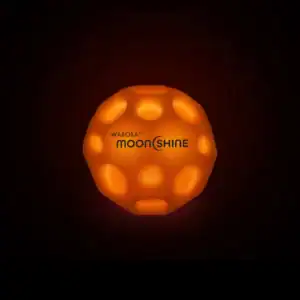 Glowing Waboba Moonshine ball in darkness.