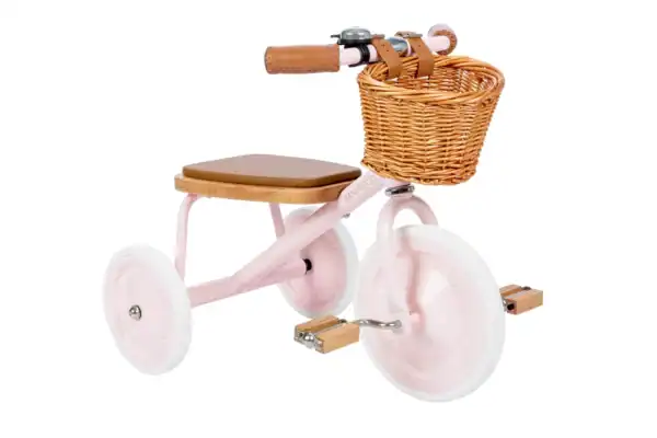 Pink tricycle with wicker basket