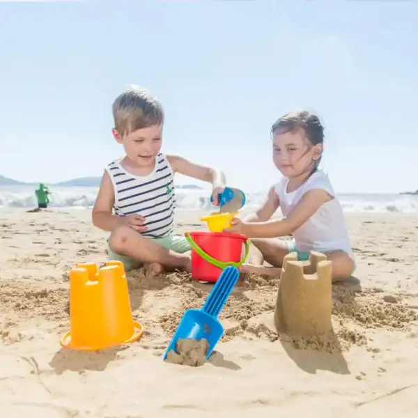 Children building sandcastles on the beach