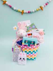 Colorful Easter basket with bunny toys and gifts.