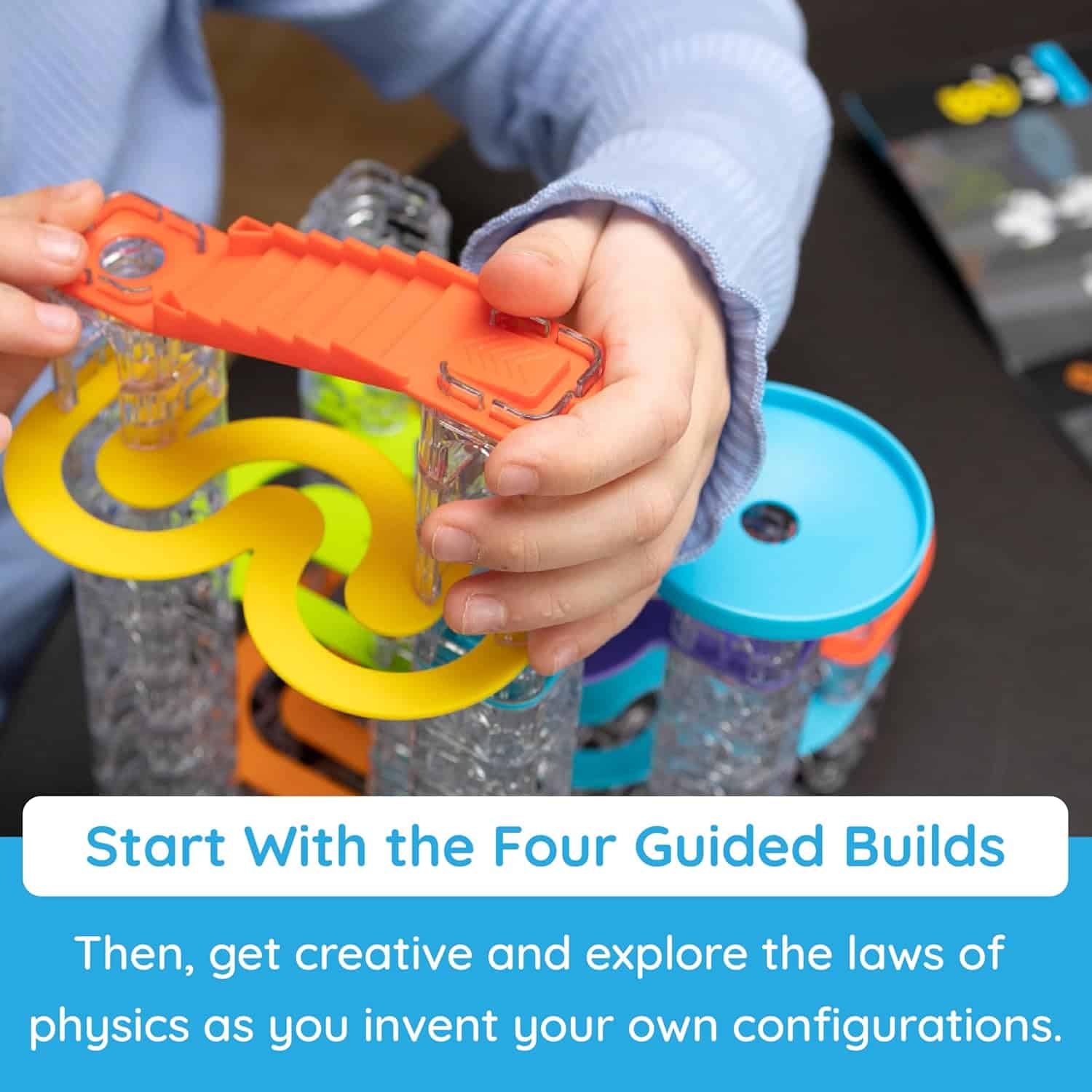 Child assembling colorful physics toy set.