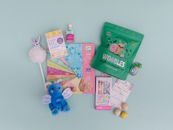 Assorted cute stationary, crochet kit, and small toys.