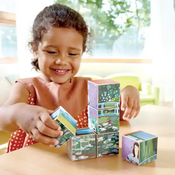 Child playing with colorful stacking blocks.